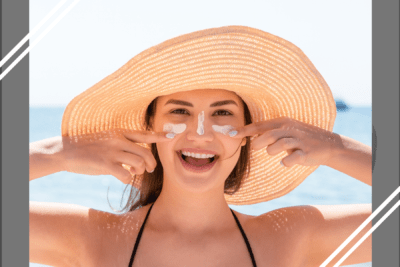 Moça de chapéu aplicando o protetor solar para prevenir o câncer de pele